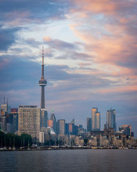 River with cn tower in background against cloudy sky