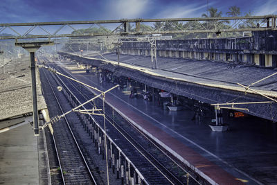 A side ariel view of an indian railway station platform before blue sky