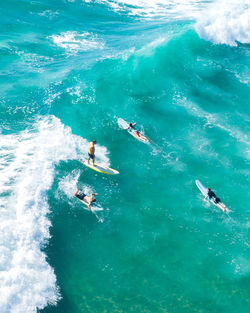 High angle view of people swimming in sea