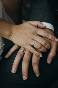 Midsection of couple holding hands