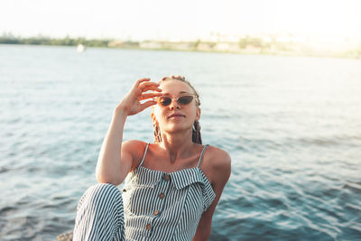 Portrait of smiling young woman by lake