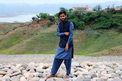 Portrait of young man standing on mountain