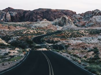 Road amidst mountains against sky