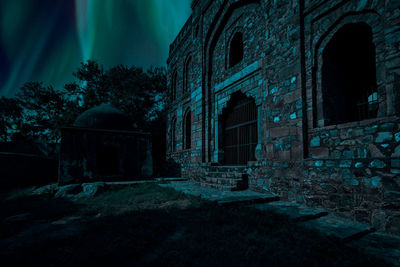 Old ruin building against sky at night