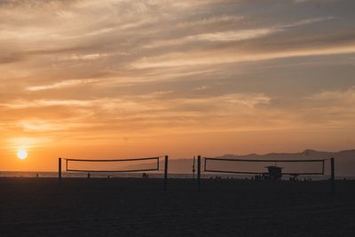 Scenic view of beach against sky during sunset