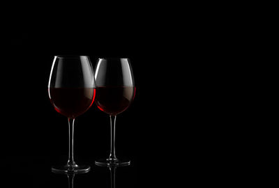 Glass of wine against black background