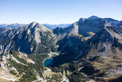 Scenic view of mountains against clear blue sky