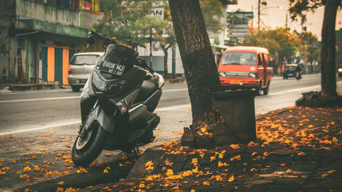 Man riding motorcycle on road in city during autumn