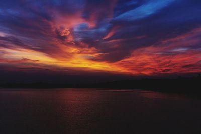 Scenic view of dramatic sky over sea during sunset