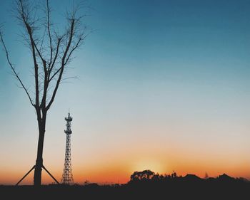 Silhouette trees against sky during sunset