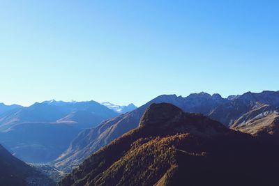 Scenic view of mountains against clear blue sky