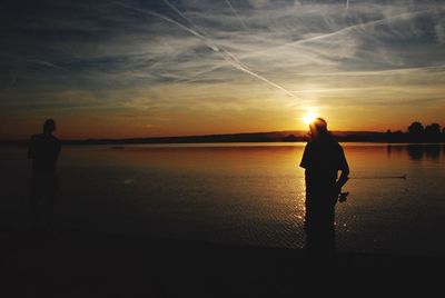 Silhouette of people at sunset