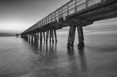 Pier over sea against sky