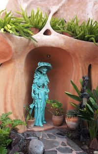 Close-up of statue against potted plants