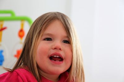 Close-up portrait of cute girl at home