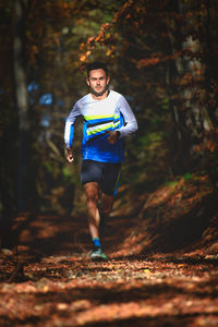 Full length of man running in forest