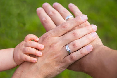 Midsection of couple holding hands