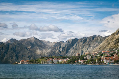 Scenic view of sea by town against sky