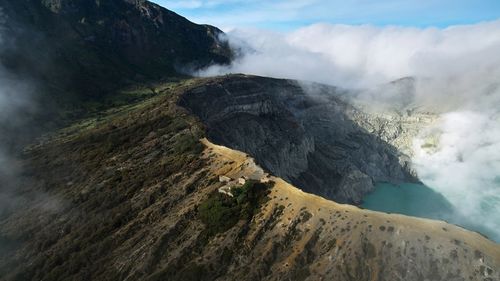 Smoke emitting from volcanic mountain against sky