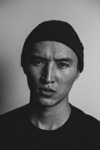 Portrait of young man against white background