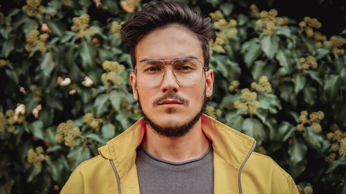 Portrait of young man against plants