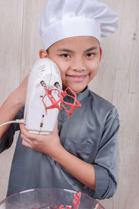 Portrait of boy preparing food in kitchen