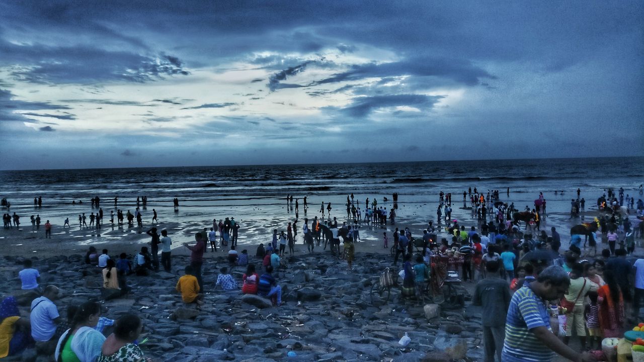 PANORAMIC VIEW OF PEOPLE ON BEACH