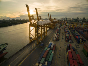 Panoramic view of commercial dock against sky during sunset