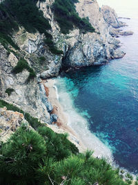 High angle view of rocks on sea shore