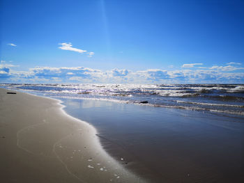 Scenic view of beach against blue sky