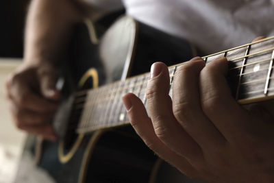 Cropped hand playing guitar