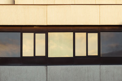 Building against sky seen through glass window