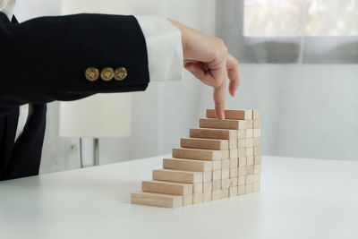 Human hand holding a stack of a table