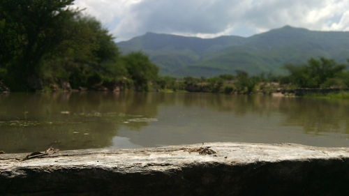 Scenic view of lake and mountains against sky