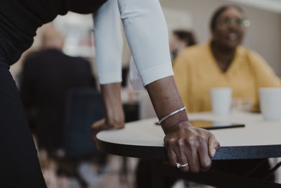 Midsection of businesswoman with female colleague at corporate office