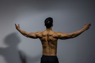 Rear view of shirtless muscular man