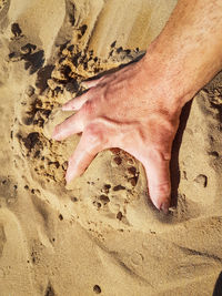Low section of man on sand