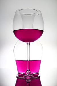 Close-up of wineglass against white background