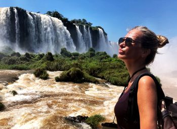 Woman standing by iguacu falls