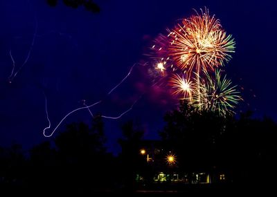 Low angle view of firework display at night