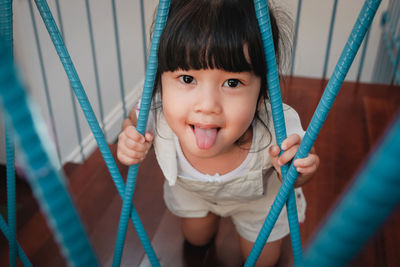 Portrait of cute girl sticking out tongue