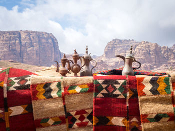Vintage kettles and carpets against mountains