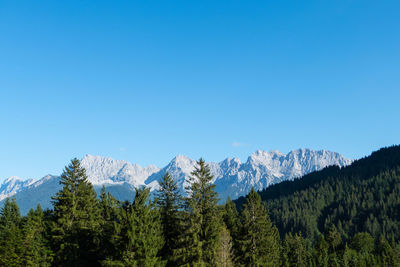 Scenic view of mountains against clear blue sky