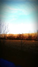 Scenic view of field against sky at sunset