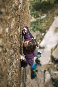 High angle view of woman rock climbing