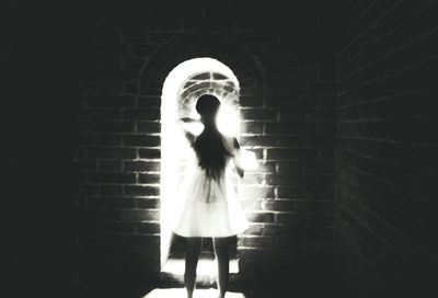 Close-up of woman standing in the dark