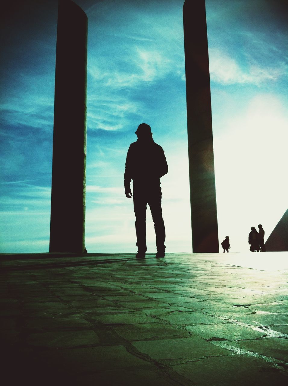 silhouette, full length, lifestyles, sky, men, rear view, leisure activity, standing, walking, low angle view, cloud - sky, person, built structure, childhood, sunlight, indoors, boys