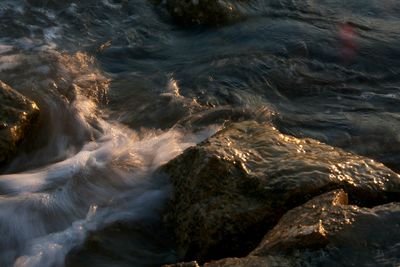 High angle view of water flowing through rocks