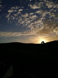 Silhouette landscape against sky during sunset