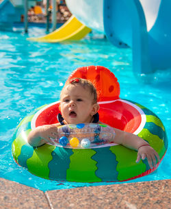 Portrait of boy swimming in pool